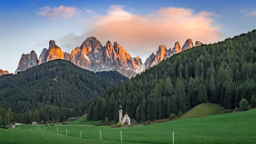 a mountain range with a church in the foreground