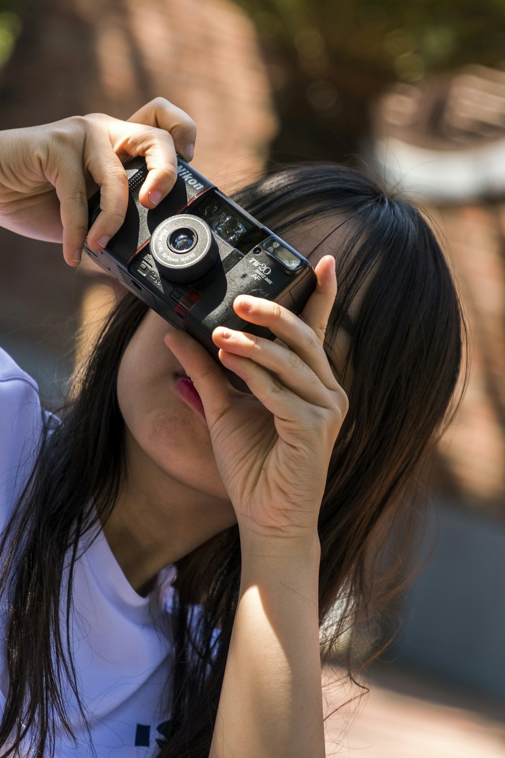 selective focus photography of woman holding camera