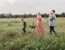 woman holding man and toddler hands during daytime