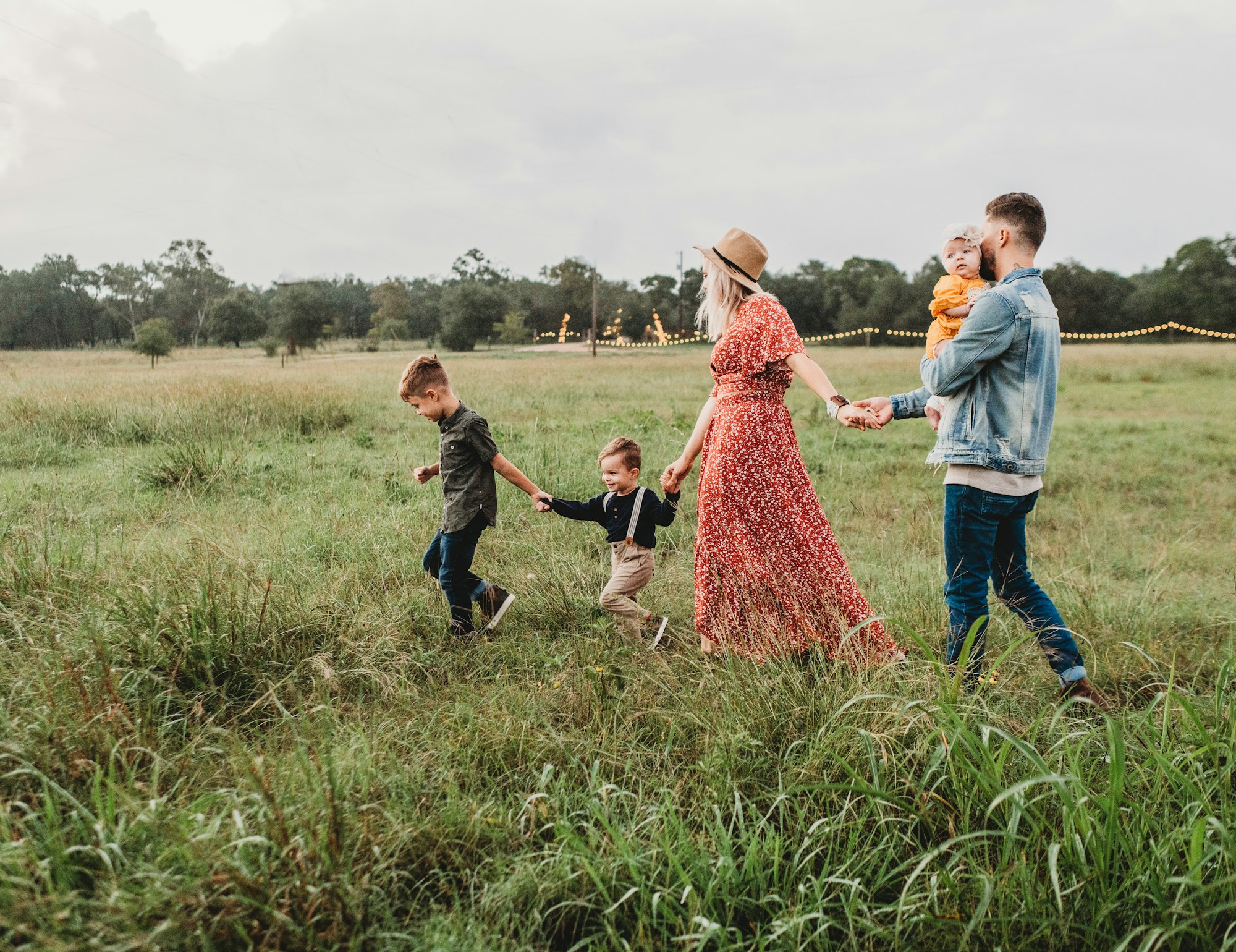 Parents and children embracing in a sunny meadow