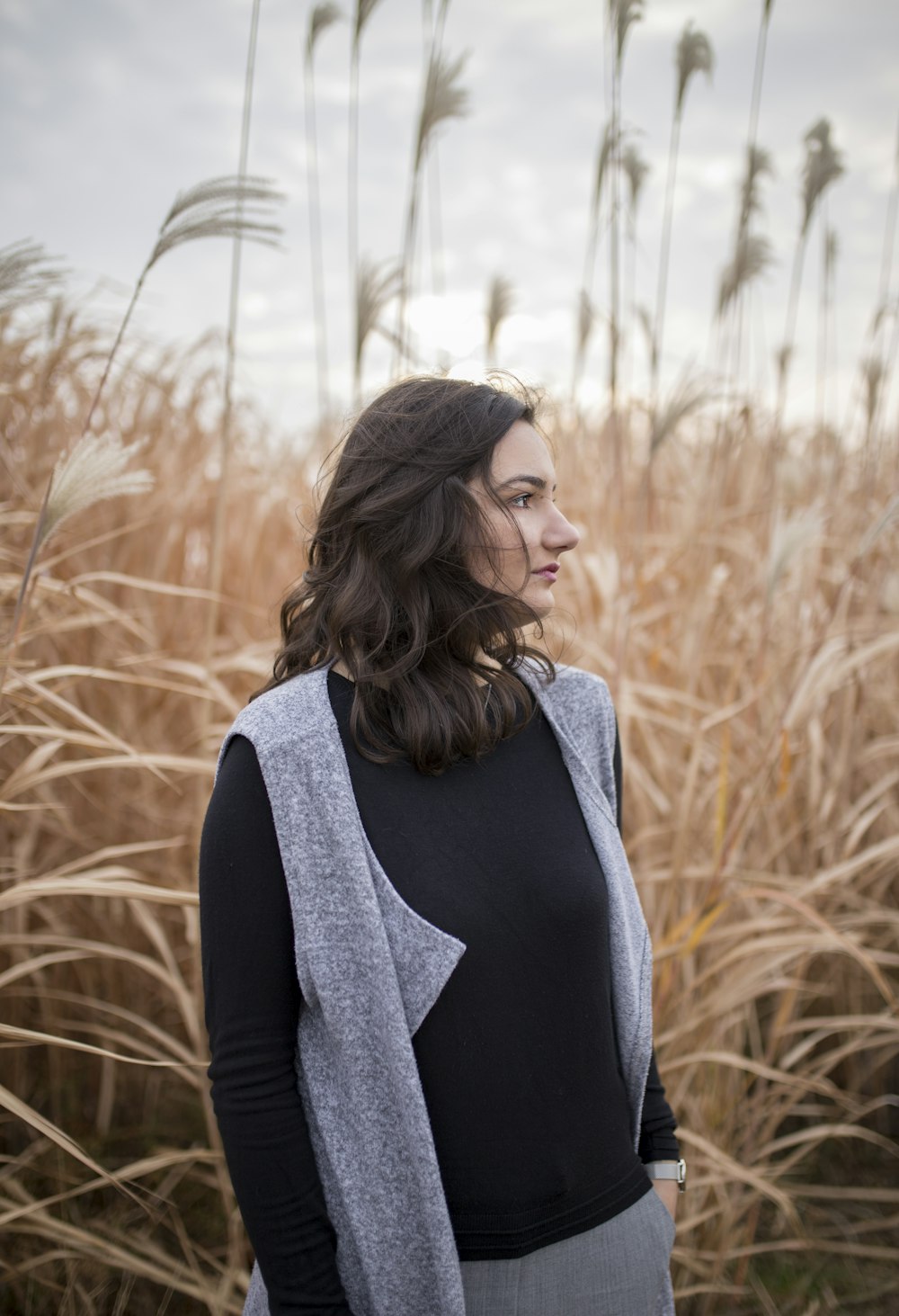 woman standing on brown grass field