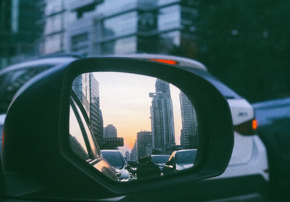 view of buildings reflected on side mirror