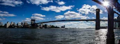A panoramic view of a large bridge project spanning a river, showcasing impressive engineering work.