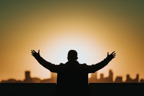 man raising both hands