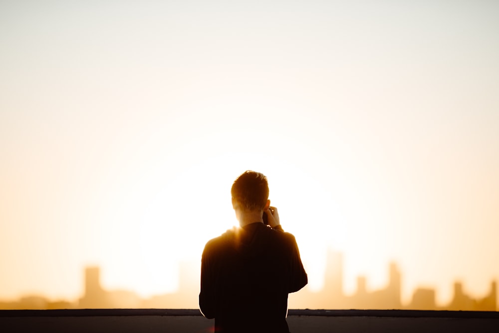 standing man wearing black shirt during daytime