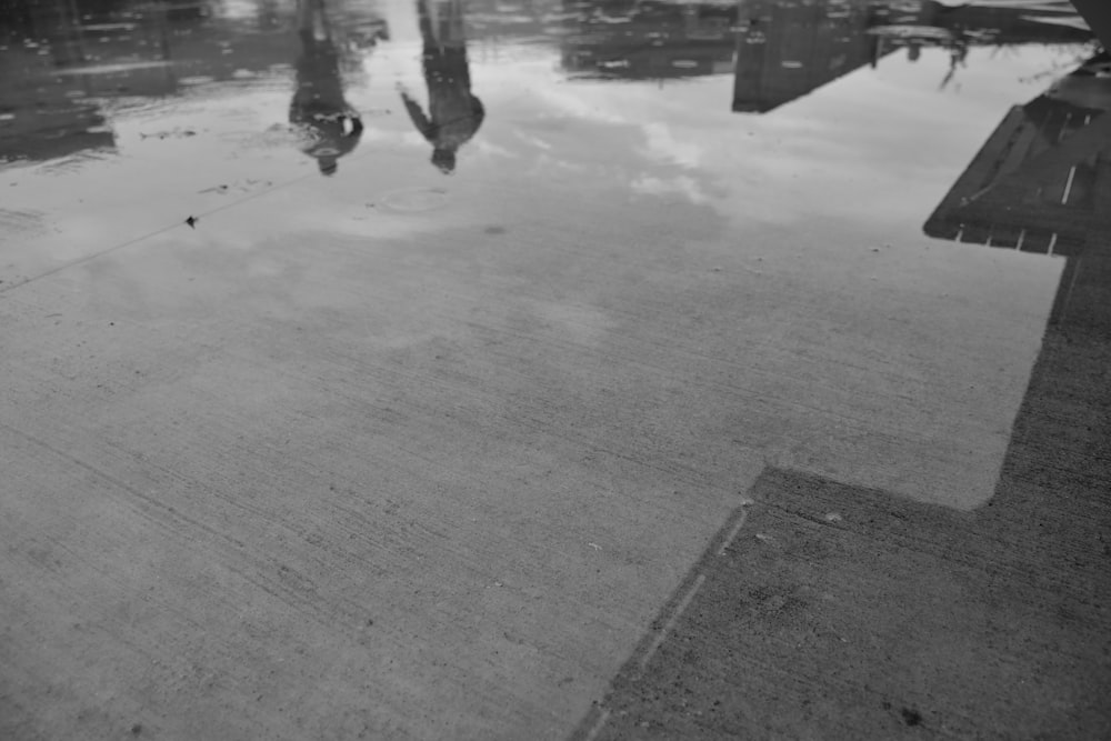a black and white photo of a puddle of water