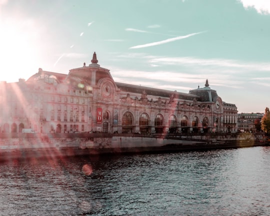 gray and black building beside body of water during daytime in Musée d'Orsay France