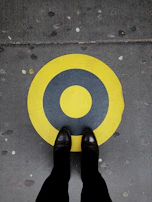 A pair of durable labor protection shoes placed on a concrete floor.