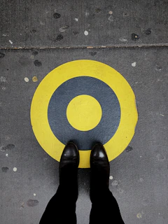 A pair of durable labor protection shoes placed on a concrete floor.