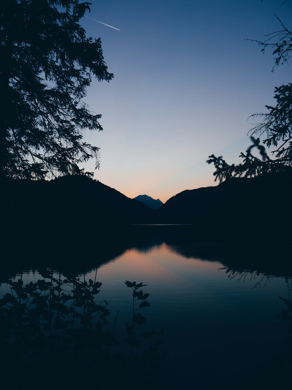 silhouette of mountain, lake and trees in nature photography