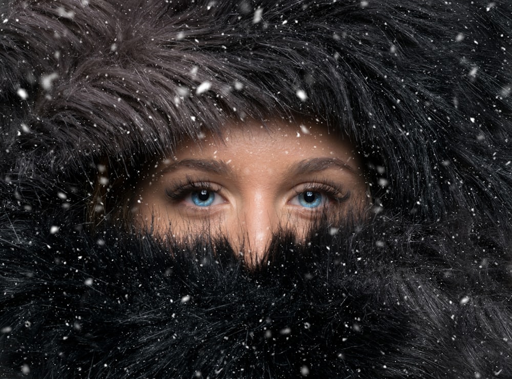 woman covered with black furred headscarf during winter