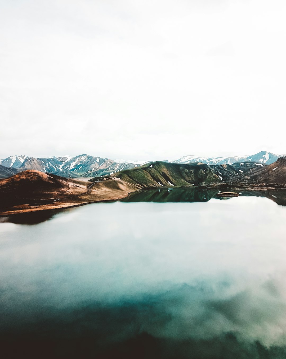 body of water across brown mountain