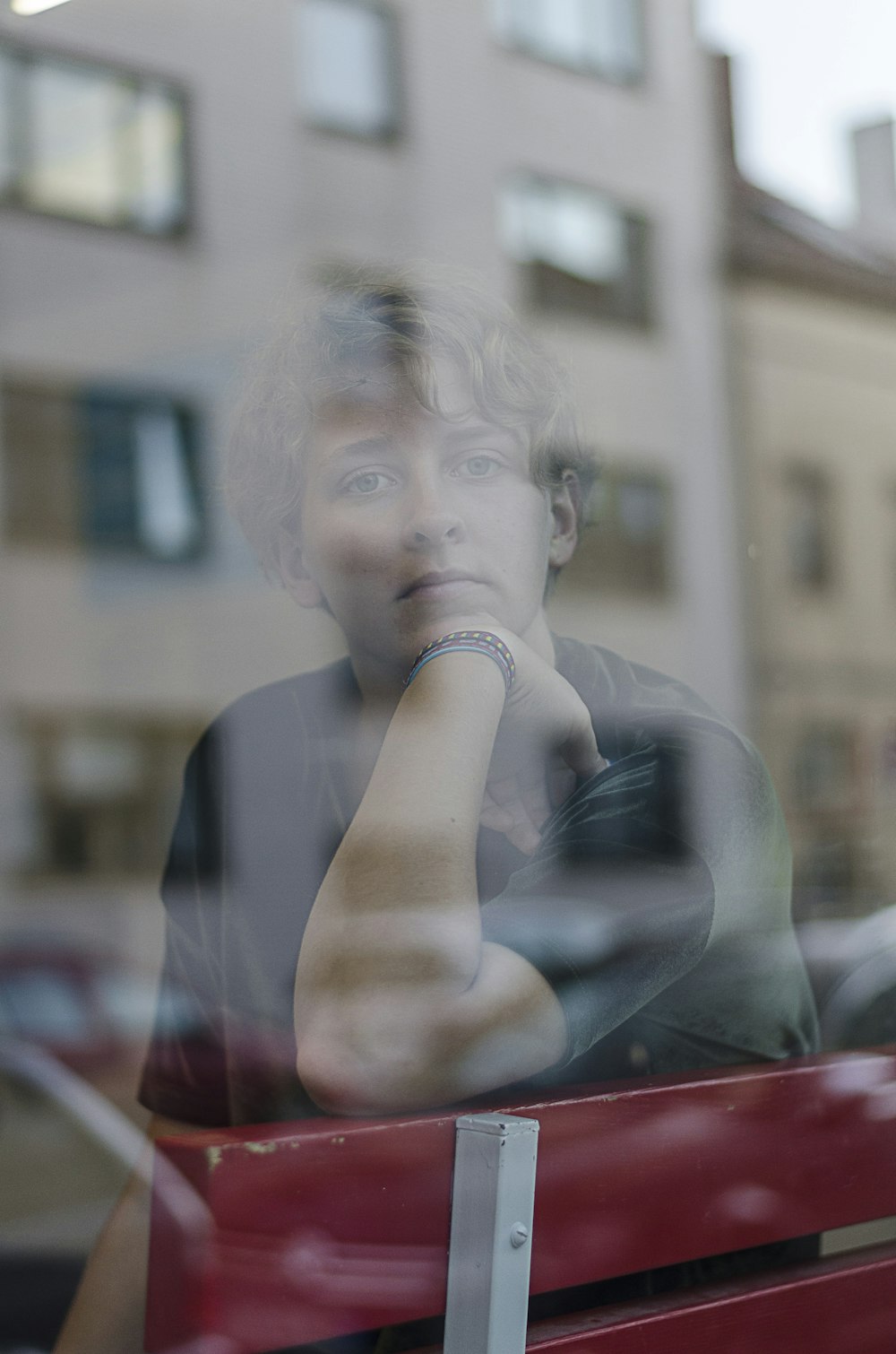 man sitting beside glass window