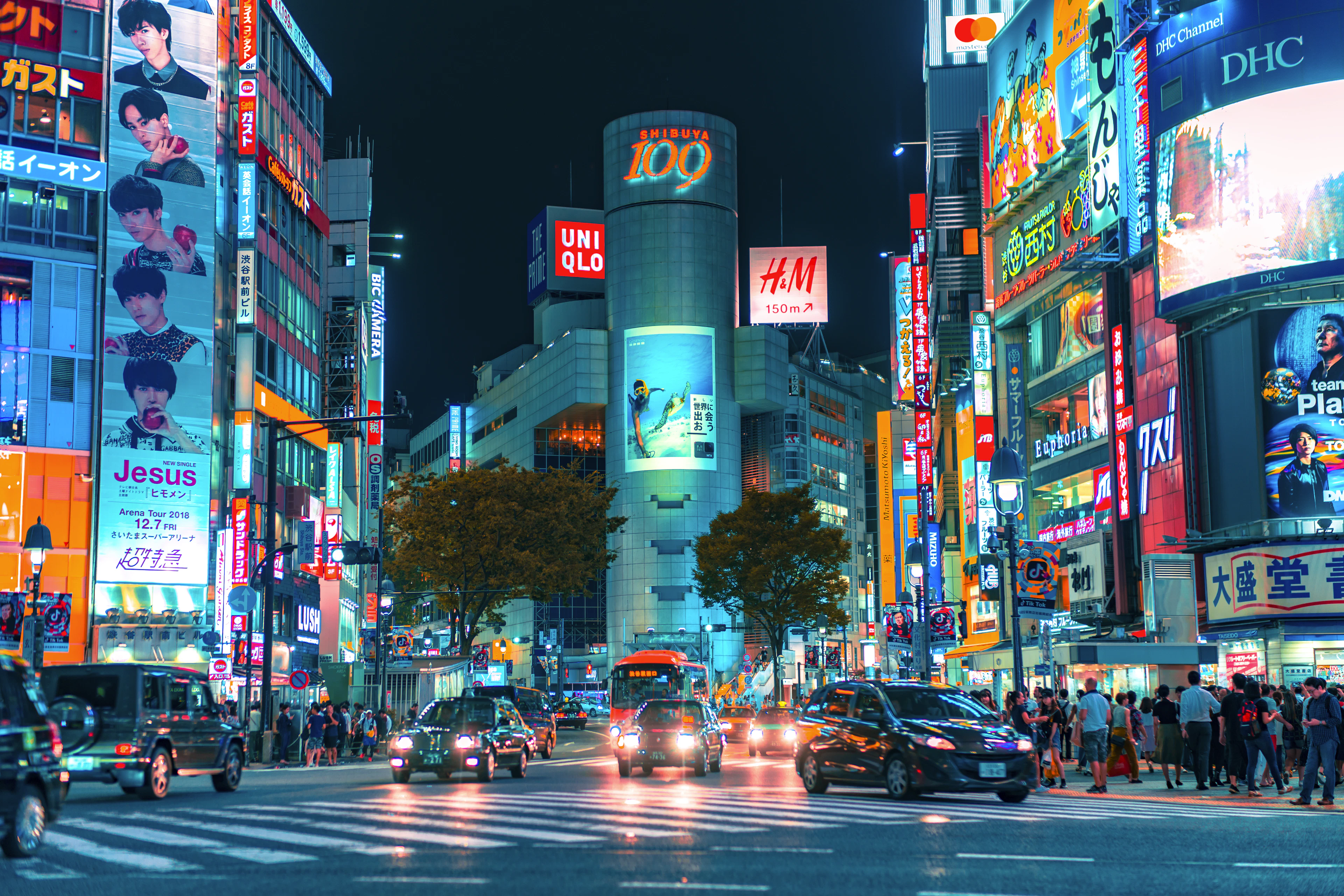 A neon-lit Shibuya street at night