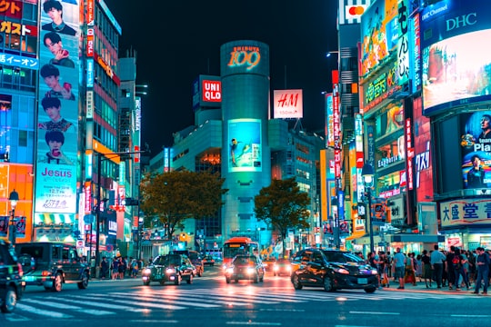 people gathered outside buildings and vehicles in Shibuya Japan