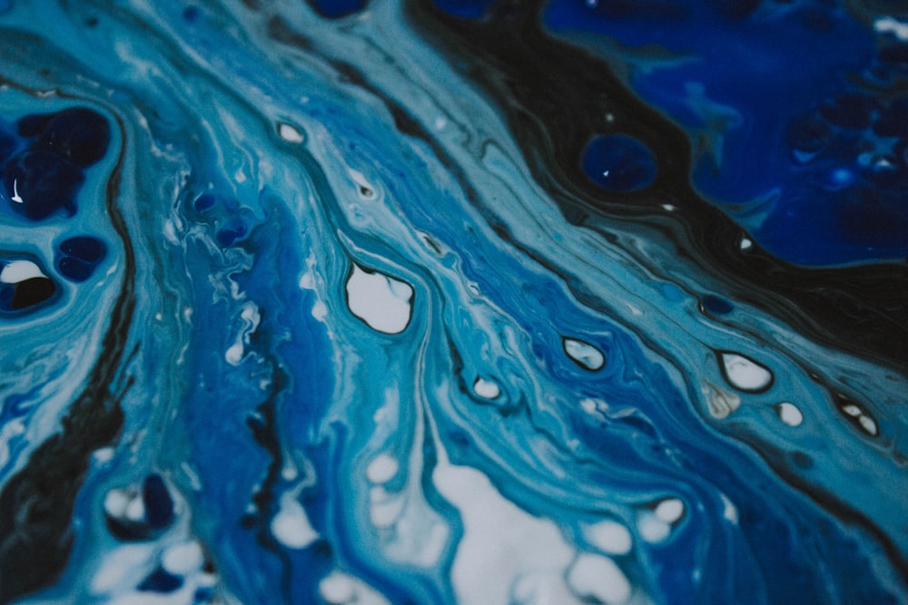 a close up of a blue and black marble