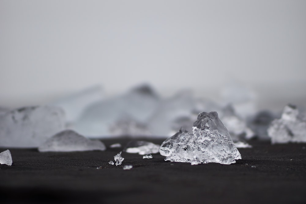 closeup photography of ice on black surface