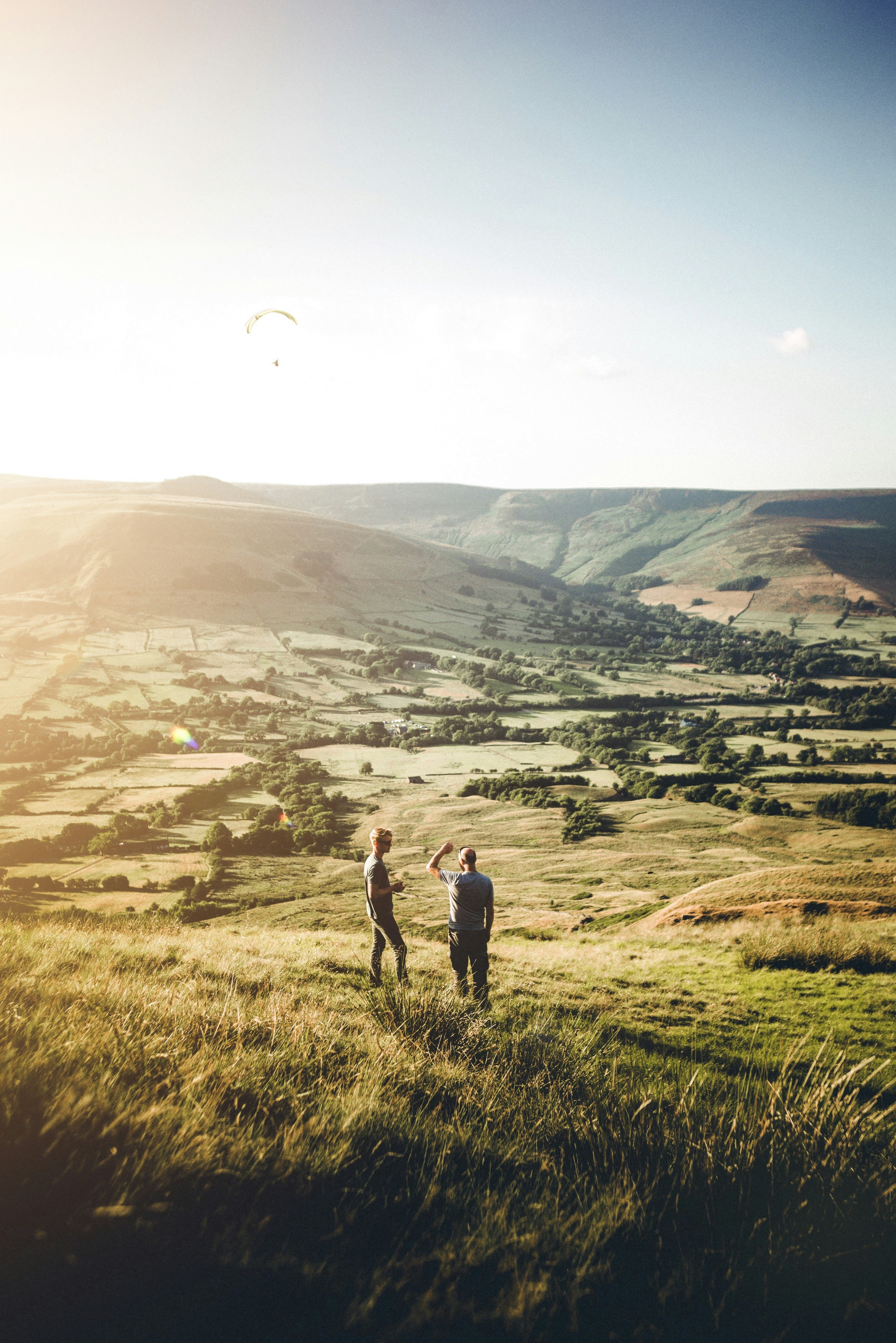 two person standing on grass during daytime