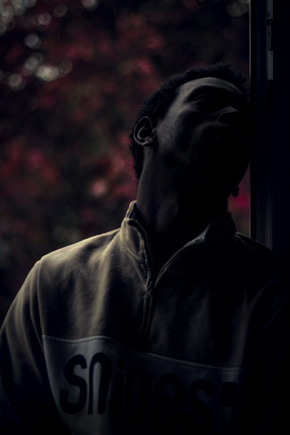 man leaning on glass window