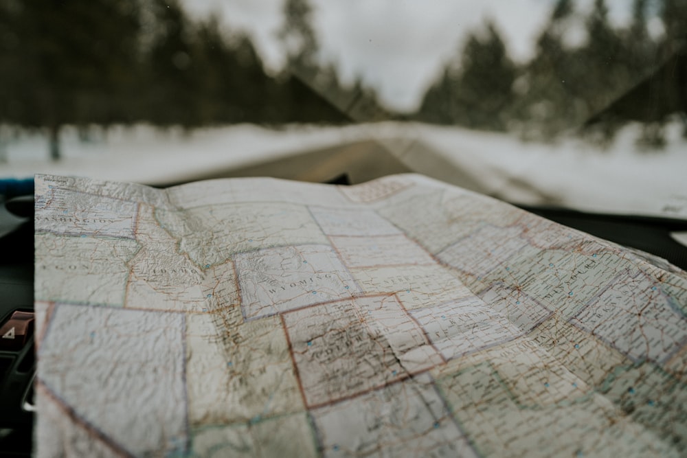 macro photography of map chart inside car