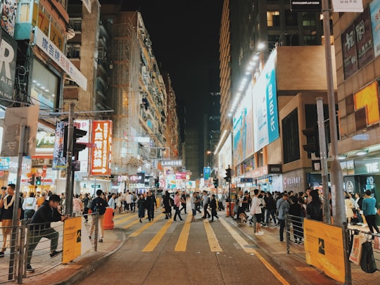 person walking on street in Mong Kok Hong Kong