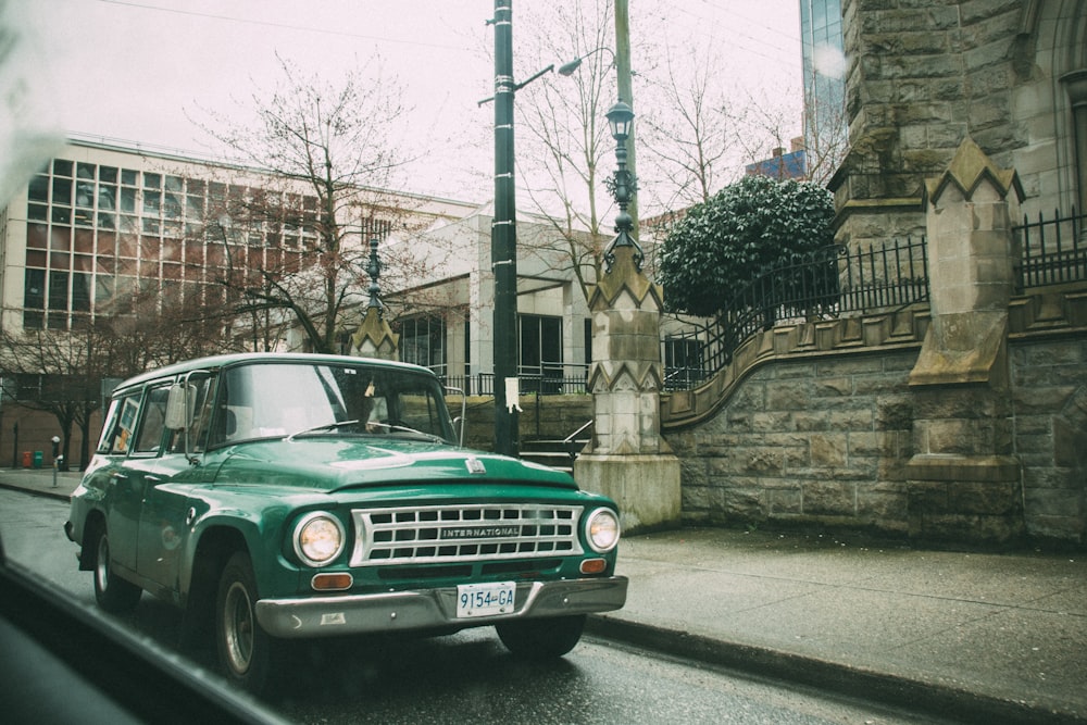 classic green station wagon on road during daytime