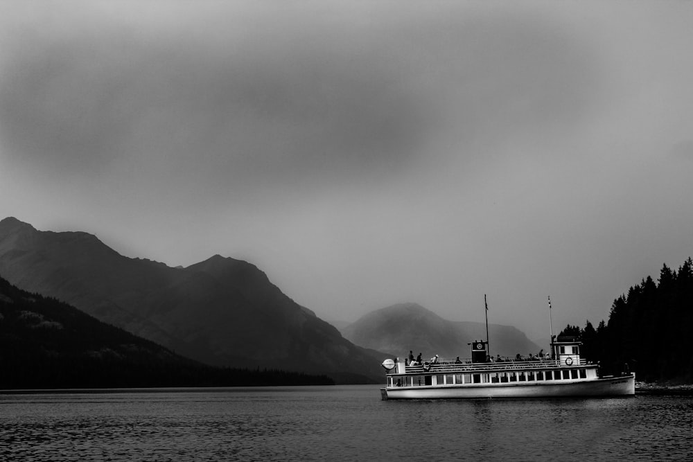 ship on body of water near hills