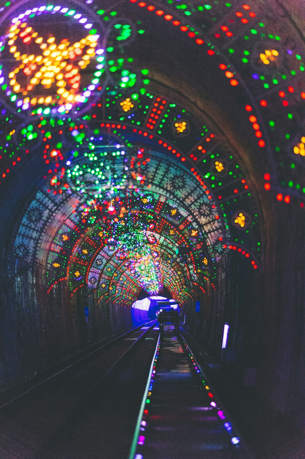 train railway surrounded by string lights