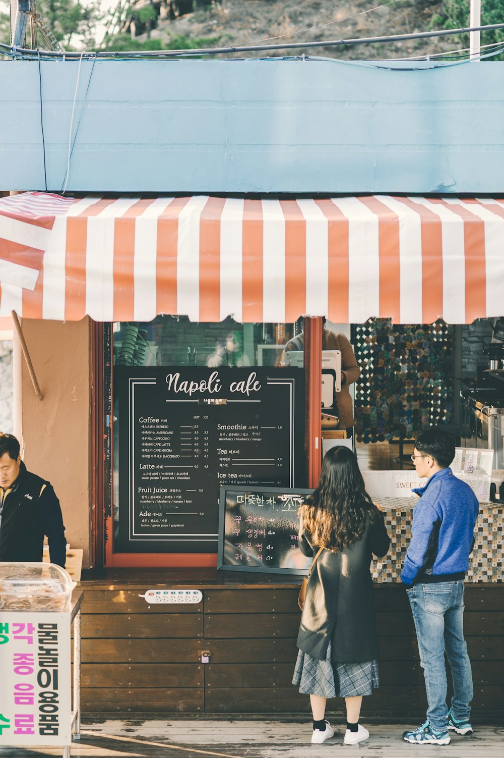 two persons looking at food menu