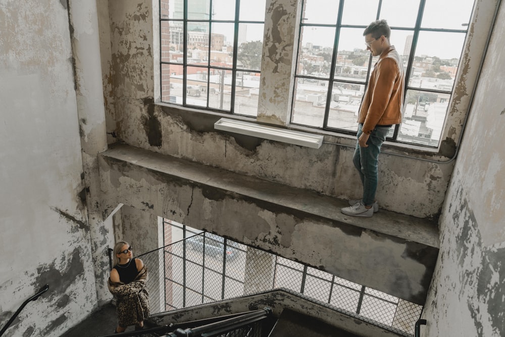 person standing near woman inside building