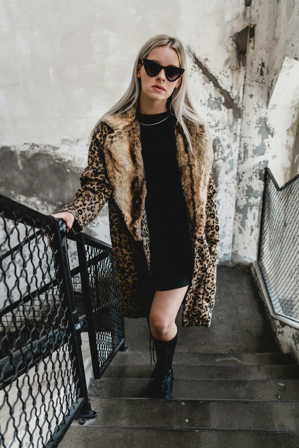 woman standing on gray stairs