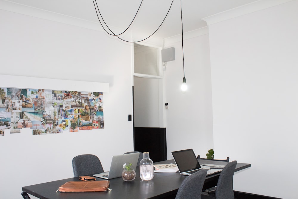 rectangular black wooden desk in white painted wall room