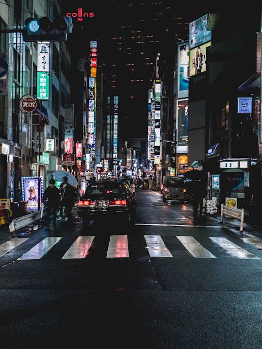 black car on road during nighttime in Shinjuku Japan