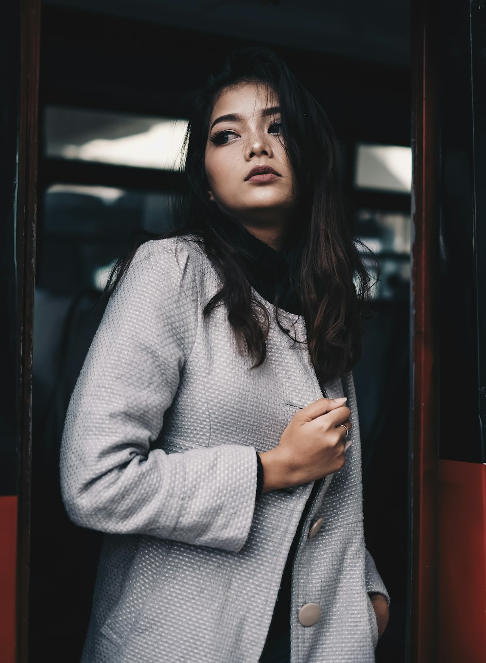 portrait photography of woman near door