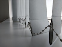 Close-up of a modern vertical blind with textured fabric in a bright room.