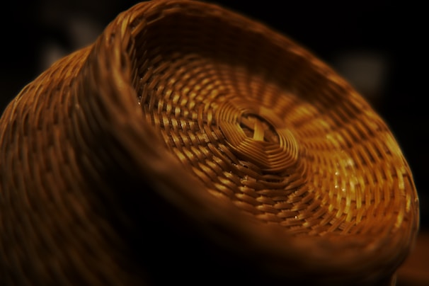 Close-up of hands weaving traditional Gullah baskets, showcasing intricate craftsmanship and cultural heritage.