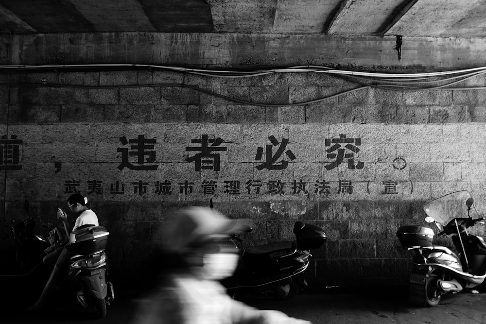 a group of motorcycles parked next to a wall