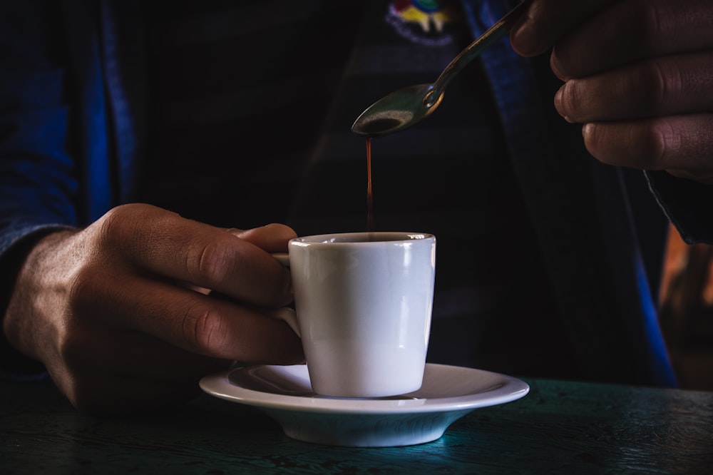 person holding ceramic mug