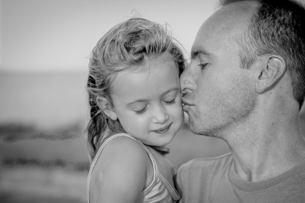 boy kissing her daughter