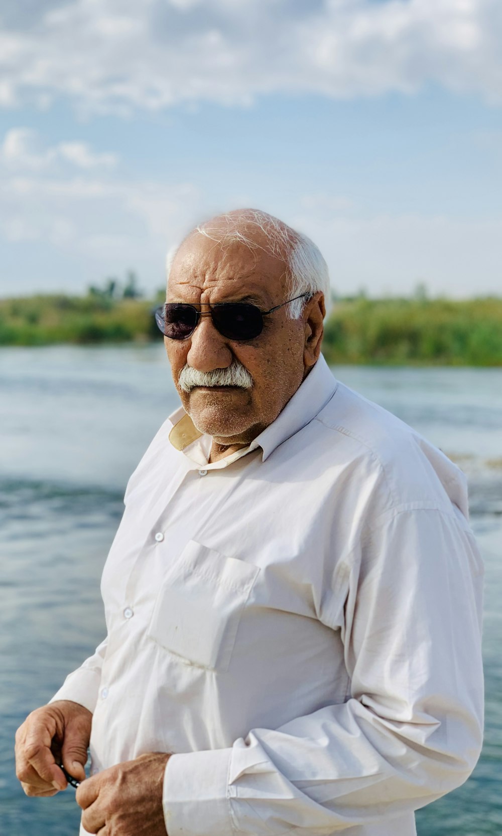 man wearing dress shirt and sunglasses