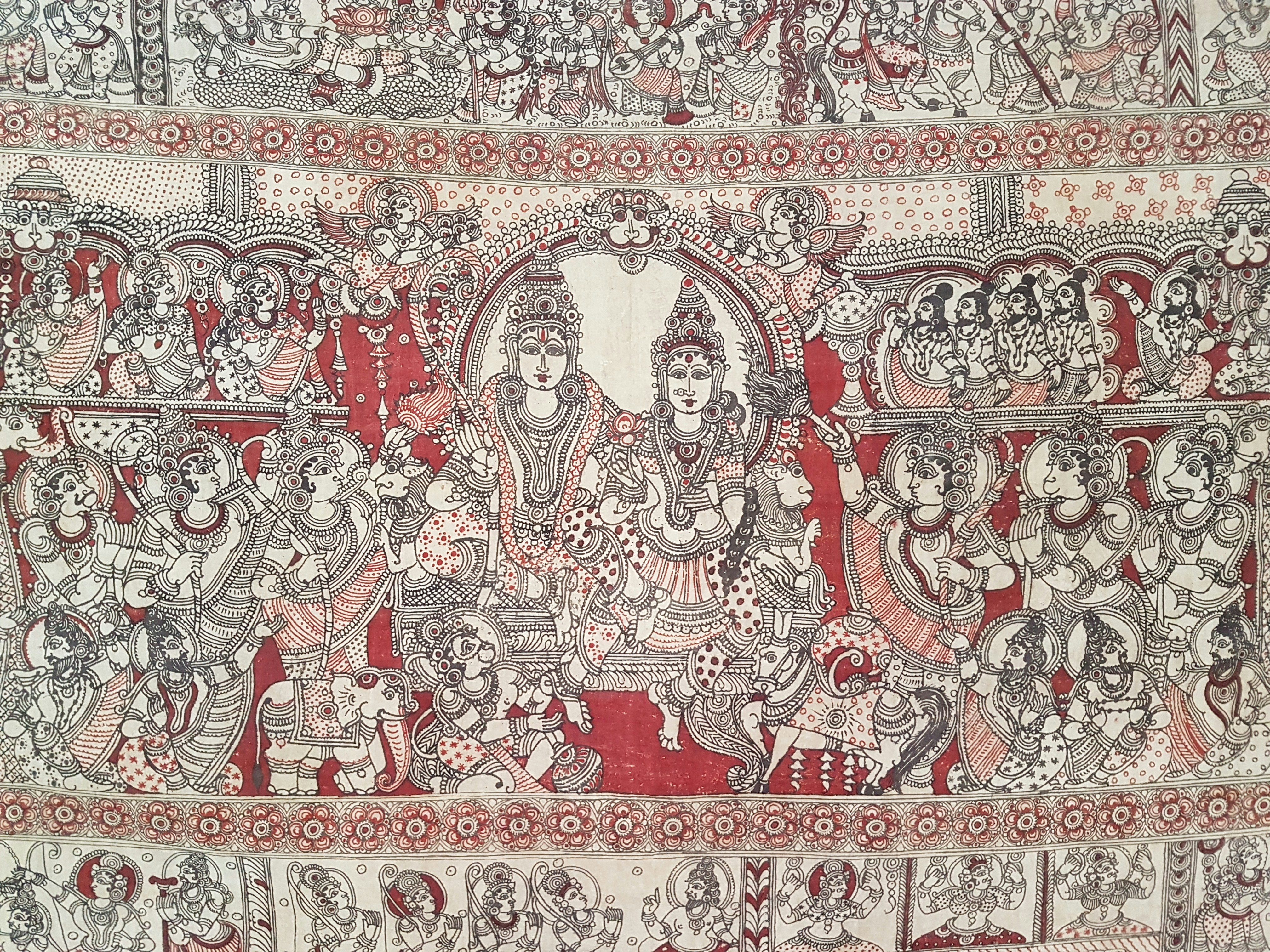 Traditional Indian tribal art painting with intricate white patterns on dark red ochre background