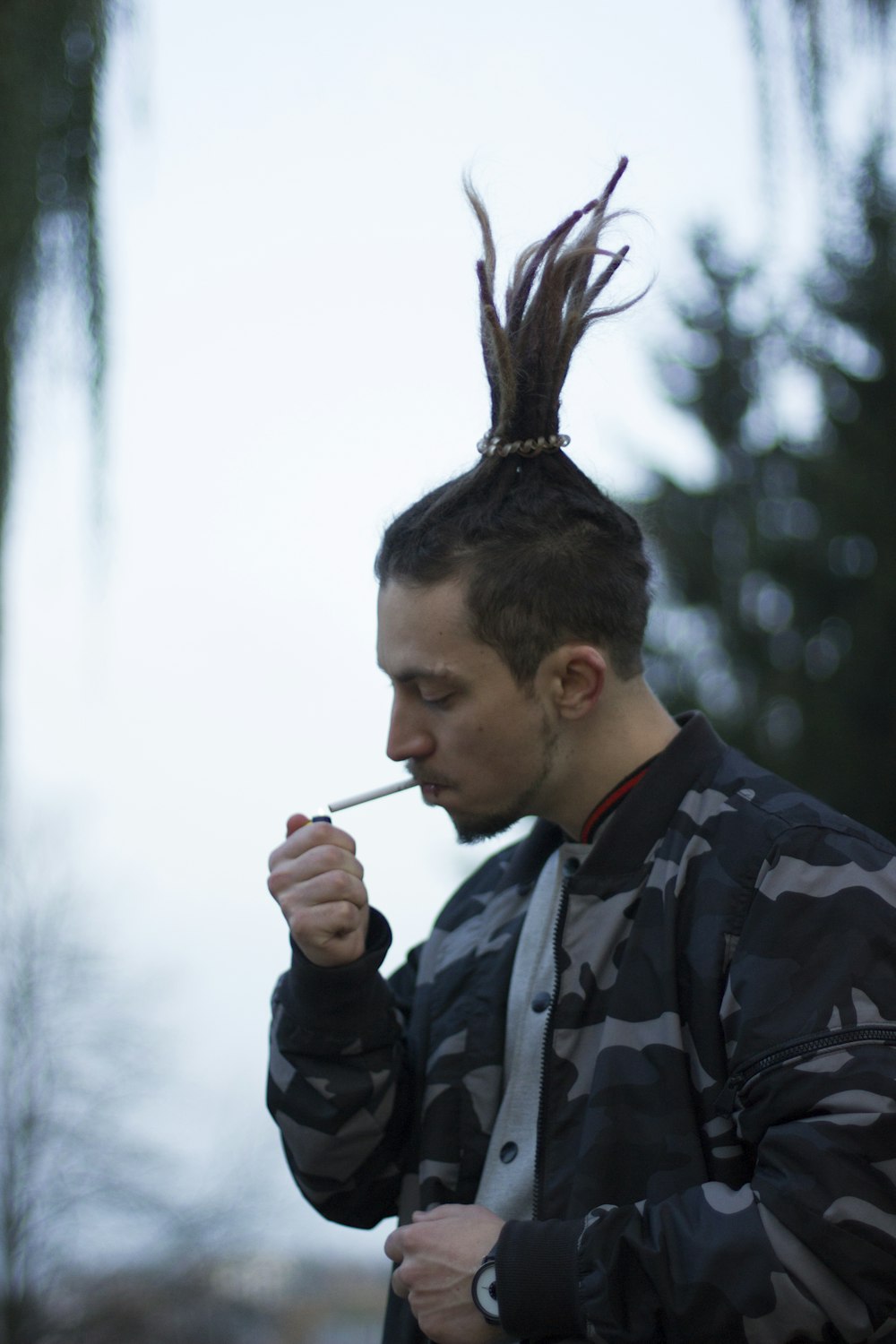 man about to light a single cigarette in his mouth