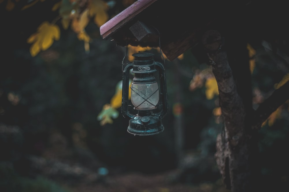 selective focus photography of black kerosene lamp