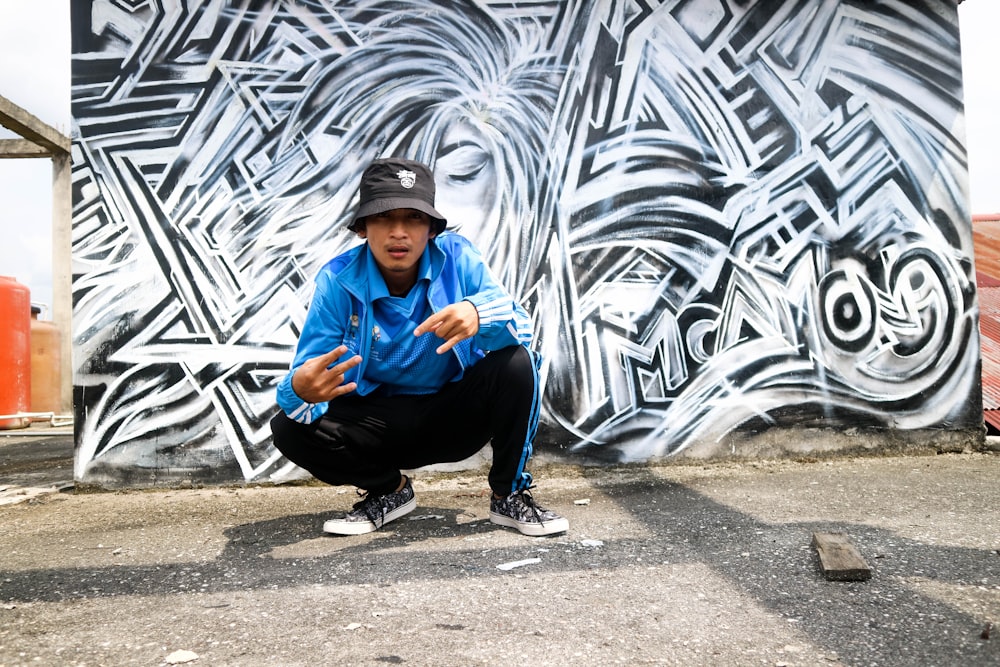 man sitting near mural