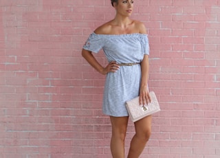 woman standing in front of pink wall