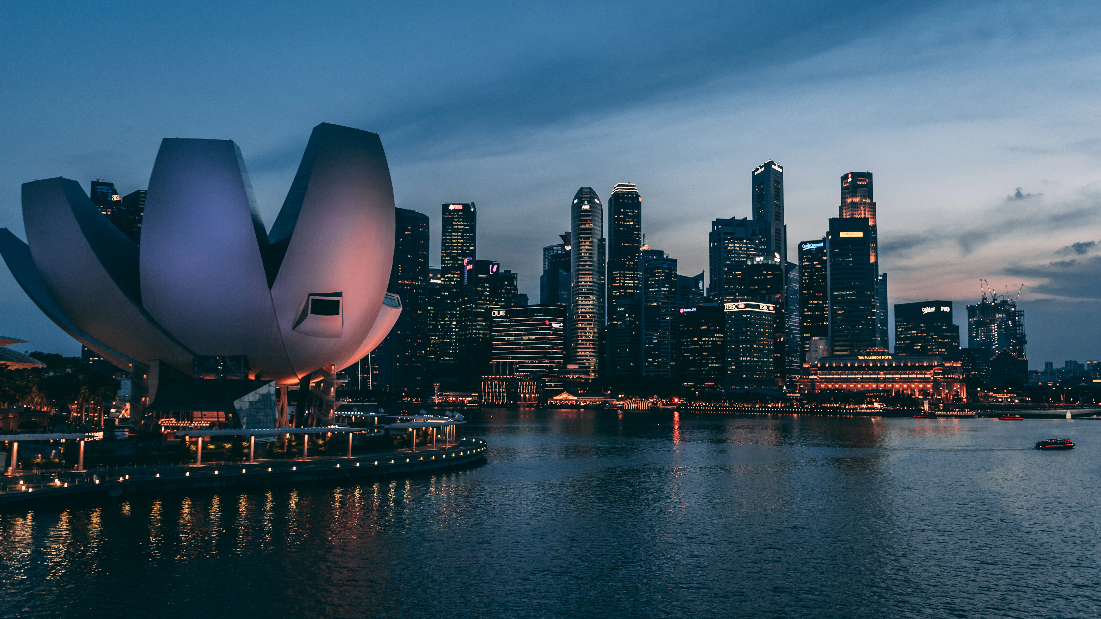 Singapore skyline across Marina Bay at dusk