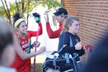 Group of diverse athletes sharing a laugh after a rigorous workout in the gym.