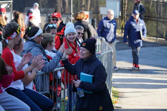 Participants registering and chatting happily before an in-person sports event.