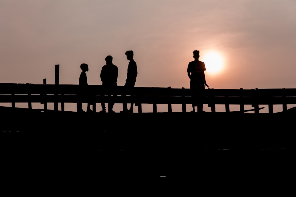 silhouette photography of four people