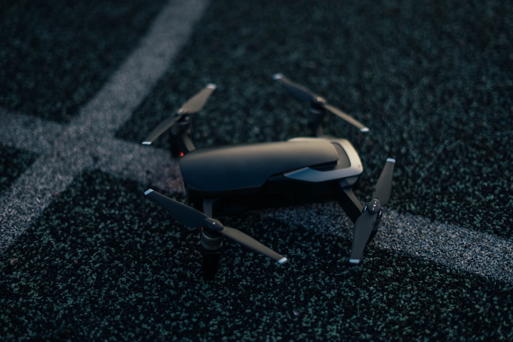 black quadcopter drone on floor